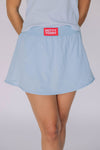 The Alli Tennis Skort Hotty Toddy Woven Label | Light Blue