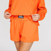 The Ava Airy Shorts War Eagle Woven Label | Orange