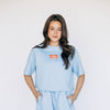 The Kristen Airy Tee War Eagle Woven Label | Light Blue