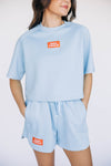 The Kristen Airy Tee War Eagle Woven Label | Light Blue