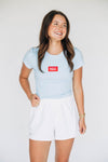 The Raegan Ribbed Baby Tee Hotty Toddy Woven Label | Light Blue