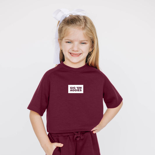 The Kristen Airy Tee Gig Em Aggies Woven Label | Youth Deep Maroon